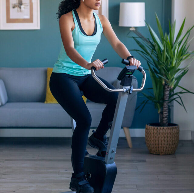 Shot,Of,Sporty,African,Young,Woman,Exercising,On,Smart,Stationary