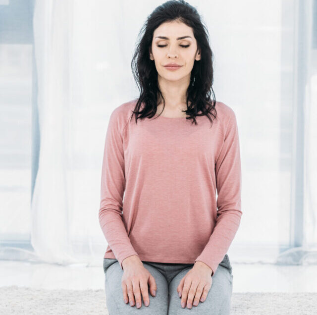 Beautiful,Woman,Practicing,Virasana,Pose,In,Living,Room,At,Home
